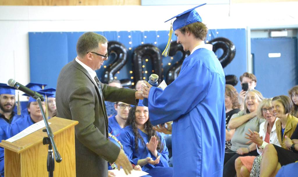 Loren Reese, principal at Kenai Alternative High School, gives Oliver Larrow the Mr. Fix It award Wednesday, May 18, 2022, at Kenai Alternative High School in Kenai, Alaska. (Photo by Jeff Helminiak/Peninsula Clarion)