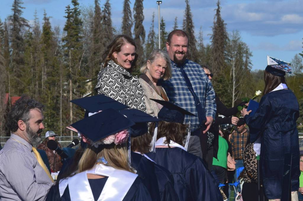 From center left: Stephanie Hunt, Penny Vadla and Tony Graham congratulate graduates receiving their diplomas during Soldotna High Schools commencement ceremony on Wednesday, May 18, 2022, in Soldotna, Alaska. (Ashlyn OHara/Peninsula Clarion)