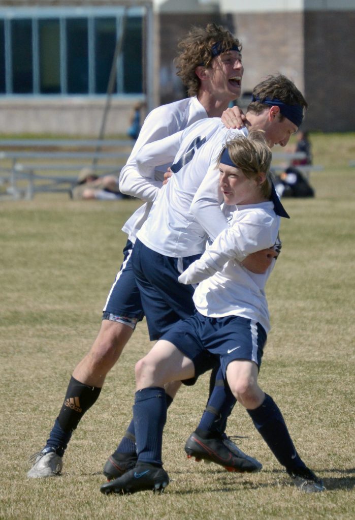 Homers Owen Pitzman (front) celebrates a goal against Soldotna on Friday, May 20, 2022, at the Peninsula Conference soccer tournament at Nikiski High School in Nikiski, Alaska. (Photo by Jeff Helminiak/Peninsula Clarion)