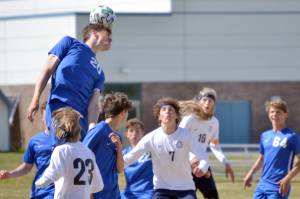 Soldotna's Hamilton Hunt rises above the crowd for a header Friday, May 20, 2022, at the Peninsula Conference soccer tournament at Nikiski High School in Nikiski, Alaska. (Photo by Jeff Helminiak/Peninsula Clarion)