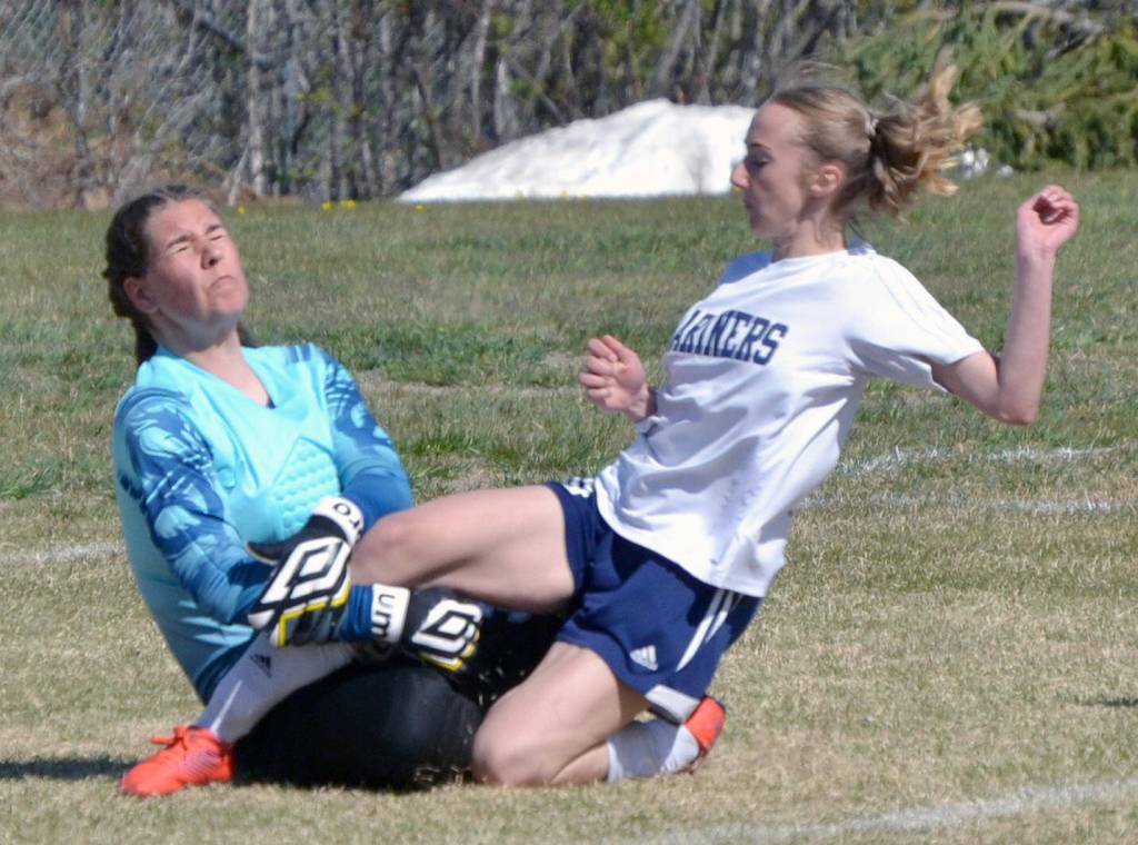 Nikiski goalie Emma Weeks makes a save on Homers Lily King on Friday, May 20, 2022, at the Peninsula Conference soccer tournament at Nikiski High School in Nikiski, Alaska. (Photo by Jeff Helminiak/Peninsula Clarion)