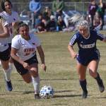 Homers Sela Weisser attacks Kenai Centrals Kate Wisnewski and Valerie Villegas in the Peninsula Conference championship game Saturday, May 21, 2022, at Nikiski High School in Nikiski, Alaska. (Photo by Jeff Helminiak/Peninsula Clarion)