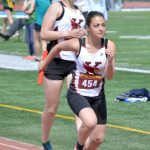 Emily Moss hands the baton to Summer Foster on the way to Kenai Central winning the 3,200-meter relay at the Region 3/Division II meet Saturday, May 21, 2022, at Ed Hollier Field at Kenai Central High School in Kenai, Alaska. (Photo by Jeff Helminiak/Peninsula Clarion)