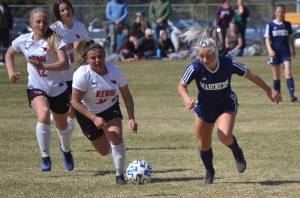Homers Sela Weisser attacks Kenai Centrals Kate Wisnewski and Valerie Villegas in the Peninsula Conference championship game Saturday, May 21, 2022, at Nikiski High School in Nikiski, Alaska. (Photo by Jeff Helminiak/Peninsula Clarion)