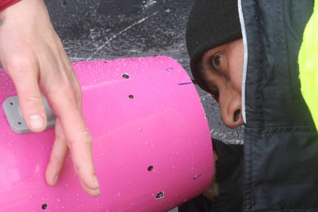 This May 4, 2022, photo shows engineer Ehsan Abdi looking from the other end as a sensor is placed inside an underwater glider on the University of Alaska Fairbanks research vessel Nanuq in the Gulf of Alaska. The glider was fitted with special sensors to study ocean acidification. (AP Photo/Mark Thiessen)