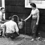 Ed Back, left, and Bill Gross chat with Ridgeway homeowner Betty Karsten as they install a natural gas hookup to her home in 1961. Betty and Emmett Karsten became Alaskas first civilian consumers of natural gas. (Photo provided by the KPC archive of historical photographs)