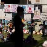 A woman visits a memorial honoring the victims killed in last weeks elementary school shooting in Uvalde, Texas, Friday, June 3, 2022. Its hard to say exactly when some Texas educators began to feel like they were under siege, but the massacre of 19 students and two teachers at Robb Elementary School is only the latest, horrific episode in a string of events dating back years. (AP Photo/Jae C. Hong)