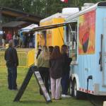 Kenai River Festival attendees order from food trucks on Friday, June 10, 2022 in Soldotna, Alaska. (Ashlyn OHara/Peninsula Clarion)