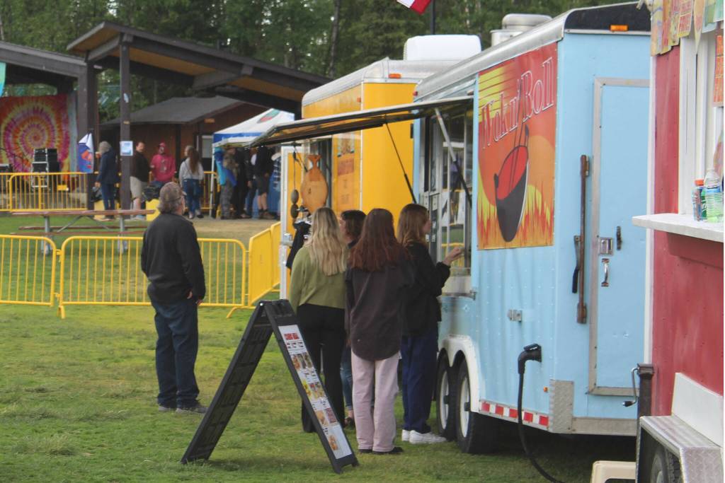 Kenai River Festival attendees order from food trucks on Friday, June 10, 2022 in Soldotna, Alaska. (Ashlyn OHara/Peninsula Clarion)