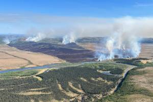 In this aerial photo provided by the BLM Alaska Fire Service, the East Fork Fire burns about 25 miles north of St. Marys, Alaska on June 2. The largest documented wildfire ever burning through tundra in southwest Alaska is within miles of two Alaska Native villages, prompting dozens of residents with respiratory problems to voluntarily evacuate. (Pat Johnson, BLM Alaska Fire Service via AP)