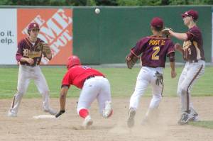 Atticus Gibson of the Post 20 Twins slides under the tag of Dimond's Shane Stephan to get out of a rundown Saturday, June 11, 2022, at Coral Seymour Memorial Park in Kenai, Alaska. (Photo by Jeff Helminiak/Peninsula Clarion)