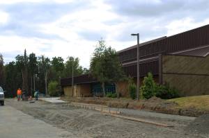 A construction crew works near the entrance of the Soldotna Regional Sports Complex on Tuesday, June 14, 2022 in Soldotna, Alaska. (Ashlyn OHara/Peninsula Clarion)