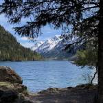Trees and rocks frame Ptarmigan Lake on Sunday, May 22, 2022 near Seward, Alaska. (Ashlyn OHara/Peninsula Clarion)