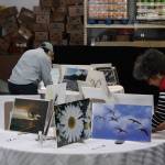 Artwork up for auction is displayed at the Kenai Peninsula Food Bank as part of its Spring Festival celebration on Thursday, June 16, 2022. (Camille Botello/Peninsula Clarion)