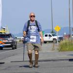 Michael Murray was the first participant to cross the finish line in the 2022 Homer Spit Run, on Saturday, June 25, 2022, at the End of the Road Park in Homer, Alaska. Murray was part of a group of about a dozen walkers who got a one-hour head start on runners. (Photo by Michael Armstrong/Homer News)