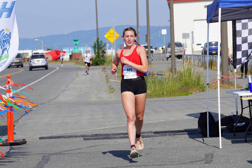 Kara Mickelson, the fourth-place woman in the 2022 Homer Spit Run Half Marathon, crosses the finish line on Saturday, June 25, 2022, at the End of the Road Park in Homer, Alaska. (Photo by Michael Armstrong/Homer News)