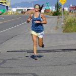 Amanda Cherok, the first-place woman runner in the 2022 Homer Spit Run, crosses the finish line on Saturday, June 25, 2022, at the End of the Road Park in Homer, Alaska. (Photo by Michael Armstrong/Homer News)