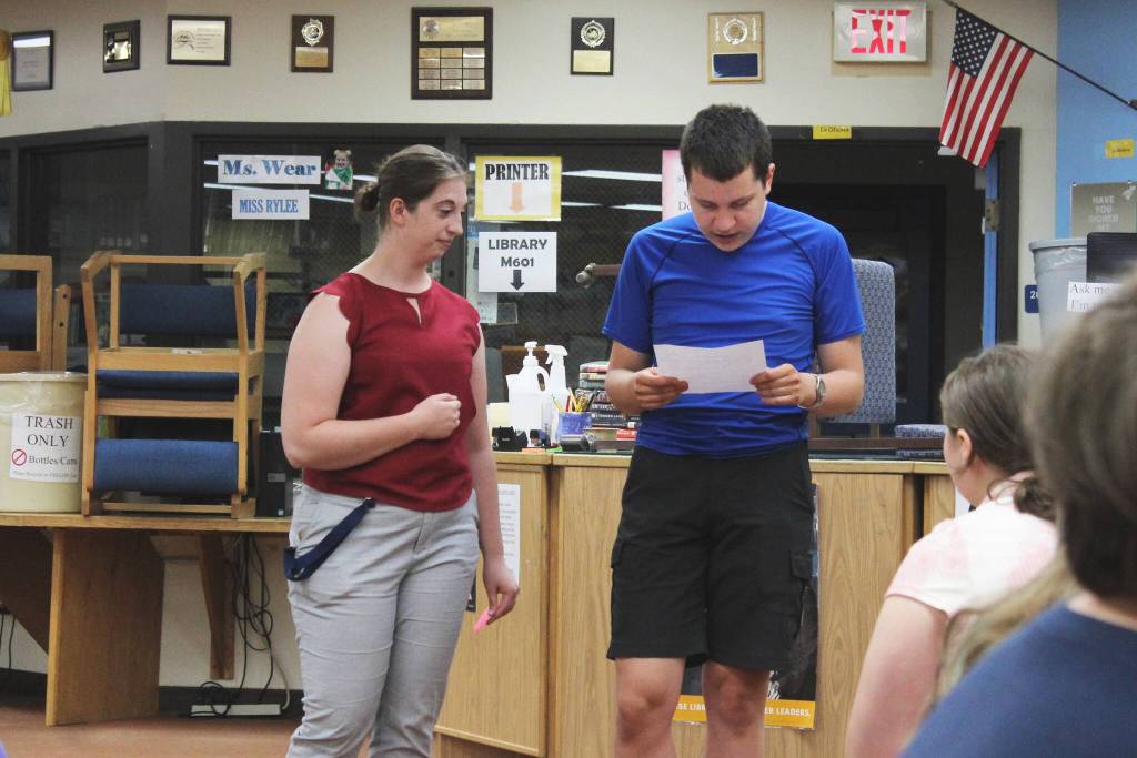 KPBSD Summer Work Program Coordinator Olivia Orth, left, assists Robert Nelson with a presentation in the Soldotna High School Library on Tuesday, June 28, 2022, in Soldotna, Alaska. (Ashlyn OHara/Peninsula Clarion)