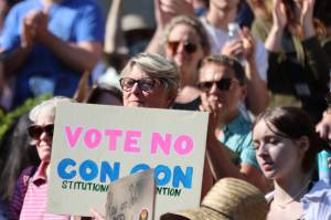 Former Democratic state Rep. Beth Kerttula holds up a sign reading "Vot No Con Con," during a Saturday rally at the Dimond Courthouse Plaza in Juneau. Opposition to a constitutional convention, which could alter the Alaska State Constitution to allow for banning abortions was a frequent topic during the protest. (Ben Hohenstatt / Juneau Empire)