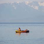 People in an inflatable kayak fish off the end of the Homer Spit on Thursday, June 23, 2022, in Homer, Alaska. (Photo by Michael Armstrong/Homer News)