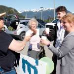 Iryna Hrynchenko and her 18 year old son, Ivan Hrynchenko, 18, Joyanne Bloom and Bridget Smith toast to the Ukrainians arrival Saturday, June 25, 2022, at Juneau Airport. Bloom and Smith are part of a five-person group of residents who raised funds to bring the Hrynchenkos to Juneau, and is helping them with housing, education and job opportunities, and in other ways. (Mark Sabbatini / Juneau Empire)