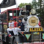 Twins baseball players take a ride on a locomotive float at the Kenai 4th of July Parade on Monday, July 4, 2022. (Camille Botello/Peninsula Clarion)