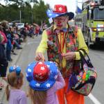 A clown hands out whistles during the annual 4th of July Parade in Kenai on Monday, July 4, 2022. (Camille Botello/Peninsula Clarion)