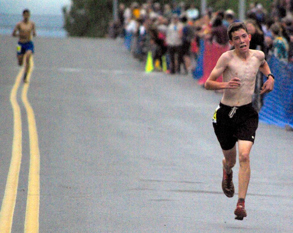 Palmers Coby Marvin finishes ahead of Ali Papillon of Boulder, Colorado, to win the boys junior Mount Marathon Race on Monday, July 4, 2022, in Seward, Alaska. (Photo by Jeff Helminiak/Peninsula Clarion)
