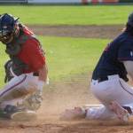 Ryan Mathiesen of the Chugiak-Eagle River Chinooks slides past Oilers catcher Carson Seeman for a run Friday, July 8, 2022, at Coral Seymour Memorial Park in Kenai, Alaska. (Photo by Jeff Helminiak/Peninsula Clarion)