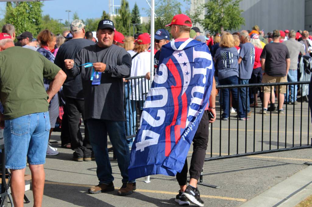 A person wearing a Trump flag stands outside of the Alaska Airlines Center, where a Save America rally was being held, on Saturday, July 9, 2022, in Anchorage, Alaska. Former President Donald Trump, U.S. Senate candidate Kelly Tshibaka and U.S. House candidate Sarah Palin were among the events speakers. (Ashlyn OHara/Peninsula Clarion)
A person wearing a Trump flag stands outside of the Alaska Airlines Center, where a Save America rally was being held, on Saturday, July 9, 2022, in Anchorage, Alaska. Former President Donald Trump, U.S. Senate candidate Kelly Tshibaka and U.S. House candidate Sarah Palin were among the events speakers. (Ashlyn OHara/Peninsula Clarion)