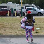 A person wearing Donald Trump and patriotic attire walks around outside of the Alaska Airlines Center, where a Save America rally was being held, on Saturday, July 9, 2022, in Anchorage, Alaska. Former President Donald Trump, U.S. Senate candidate Kelly Tshibaka and U.S. House candidate Sarah Palin were among the events speakers. (Ashlyn OHara/Peninsula Clarion)