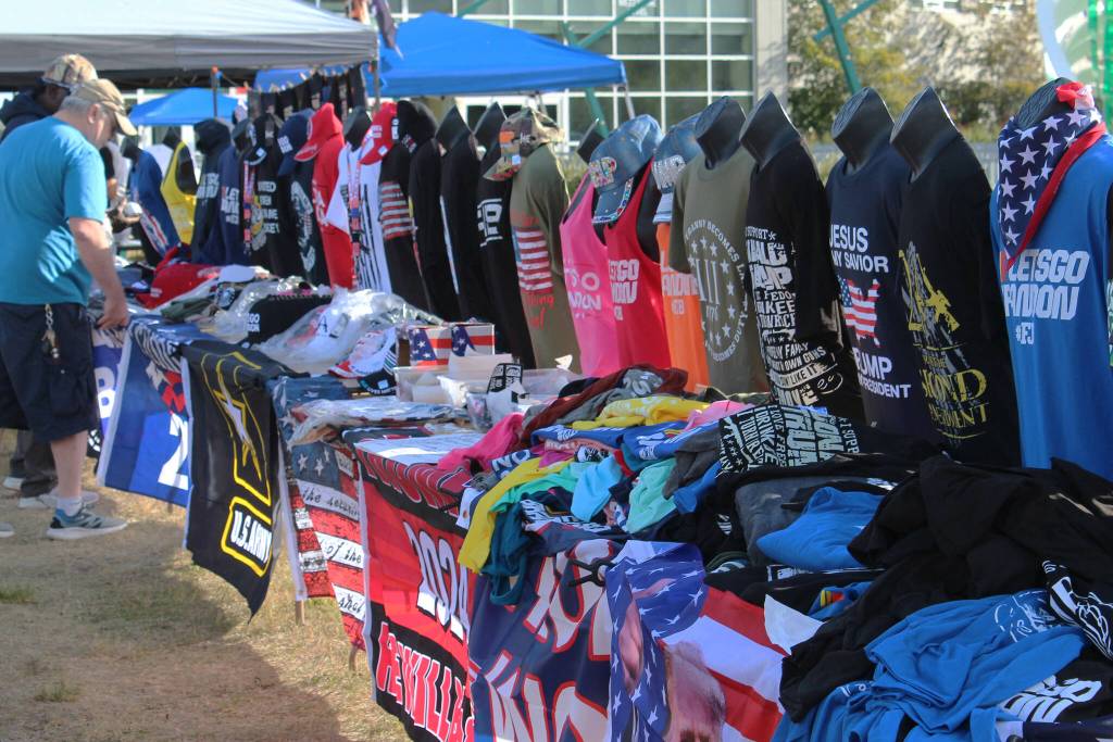 Save America rally attendees shop for merchandise outside of the Alaska Airlines Center on Saturday, July 9, 2022, in Anchorage, Alaska. Former President Donald Trump, U.S. Senate candidate Kelly Tshibaka and U.S. House candidate Sarah Palin were among the events speakers. (Ashlyn OHara/Peninsula Clarion)