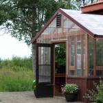 The door to a greenhouse dedicated to Bill Osborn stands open on Tuesday, July 12, 2022 in Kenai, Alaska. (Ashlyn OHara/Peninsula Clarion)
