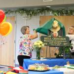 Vicke Kukowski (left) and Kathy Romain (right) unveil a plaque dedicating the Kenai Senior Centers greenhouse to Bill Osborn during a ceremony on Tuesday, July 12, 2022 in Kenai, Alaska. (Ashlyn OHara/Peninsula Clarion)