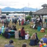 In this panormaic photo, people listen to speakers at the "Women's March: Bans Off Our Bodies" protest on Saturday, July 9, 2022, at WKFL Park in Homer, Alaska. (Photo by Michael Armstrong/Homer News)