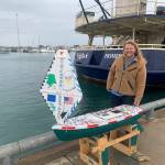 Center for Alaskan Coastal Studies CoastWalk Coordinator Henry Reiske, right, stands next to the R/V APAK before loading in onto the Alaska Maritime National Wildlife Refuge R/V Tiglax on Friday, July 15, 2022, in Homer, Alaska. (Photo by Charlie Menke)