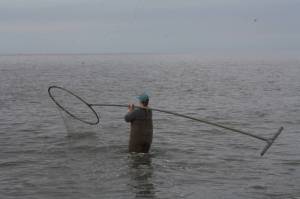 Kristen Stearns fishes at North Kenai Beach on Tuesday, July 12, 2022. (Camille Botello/Peninsula Clarion)