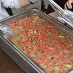 Kenai Peninsula Food Bank volunteers serve ceviche during their fundraiser at Soldotna Creek Park on Thursday, July 21, 2022. (Camille Botello/Peninsula Clarion)