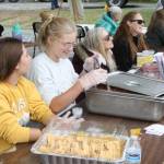 Kenai Peninsula Food Bank volunteers serve ceviche during their fundraiser at Soldotna Creek Park on Thursday, July 21, 2022. (Camille Botello/Peninsula Clarion)