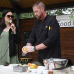 Lilly Murray, left, and Stephen Lamm from the Kenai Peninsula Food Bank give a ceviche-making demonstration at Soldotna Creek Park on Thursday, July 21, 2022. (Camille Botello/Peninsula Clarion)
