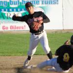 Peninsula Oilers second baseman Shunsuke Sakaino turns a double play as Dom Chacon of the Anchorage Bucs slides Friday, July 22, 2022, at Coral Seymour Memorial Park in Kenai, Alaska. (Photo by Jeff Helminiak/Peninsula Clarion)