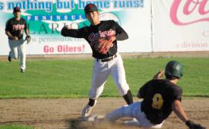 Peninsula Oilers second baseman Shunsuke Sakaino turns a double play as Dom Chacon of the Anchorage Bucs slides Friday, July 22, 2022, at Coral Seymour Memorial Park in Kenai, Alaska. (Photo by Jeff Helminiak/Peninsula Clarion)