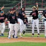 The Peninsula Oilers celebrate a home run by Noah Hennings against the Anchorage Bucs on Sunday, July 24, 2022, at Coral Seymour Memorial Park in Kenai, Alaska. Hennings hit a two-run homer in the bottom of the seventh to invoke the mercy rule in a 13-3 victory. (Photo by Jeff Helminiak/Peninsula Clarion)