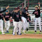 The Peninsula Oilers celebrate a home run by Noah Hennings against the Anchorage Bucs on Sunday, July 24, 2022, at Coral Seymour Memorial Park in Kenai, Alaska. Hennings hit a two-run homer in the bottom of the seventh to invoke the mercy rule in a 13-3 victory. (Photo by Jeff Helminiak/Peninsula Clarion)