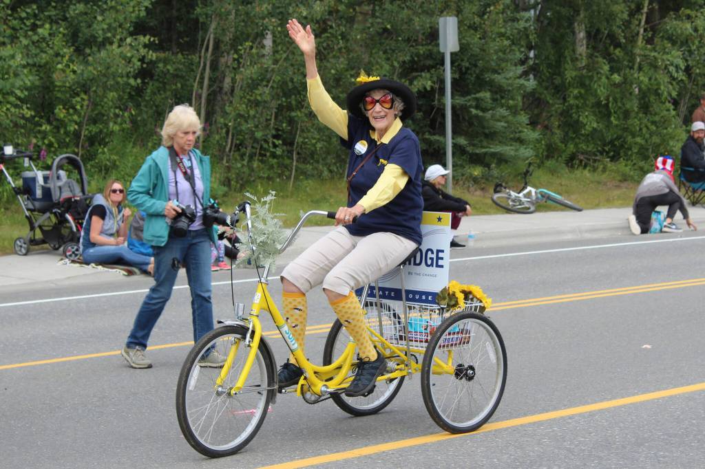 A supporter of 2022 Alaska State House candidate Justin Ruffridge waves during the 65th annual Soldotna Progress Days Parade on Saturday, July 23, 2022, in Soldotna, Alaska. (Ashlyn OHara/Peninsula Clarion)