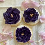 Sugar cookies are decorated with flowers of royal icing. (Photo by Tressa Dale/Peninsula Clarion)