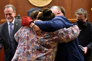 Alaskans for Better Government members La quen náay Liz Medicine Crow, Richard Chalyee Éesh Peterson and Wáahlaal Gidáak Barbara Blake embrace on the floor of the Alaska State Senate on Friday, May 13, 2022, following the passage of House Bill 123, a bill to formally recognize the states 229 already federally-recognized tribes. Gov. Mike Dunleavy is scheduled to sign the bill during a ceremony Thursday during a ceremony in Anchorage. (Peter Segall / Juneau Empire)