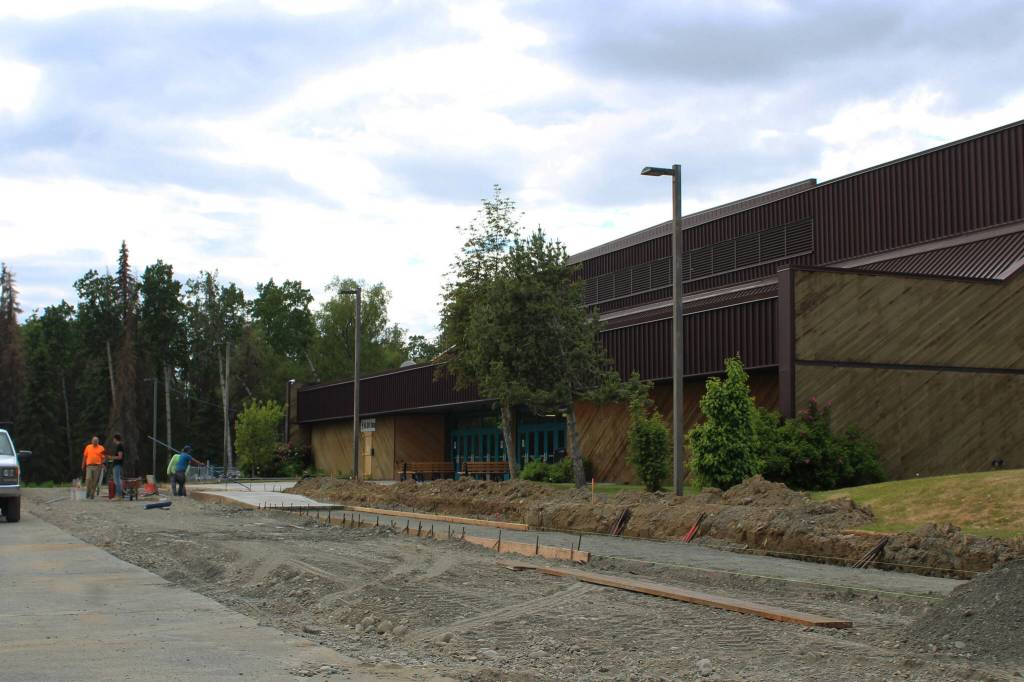 A construction crew works near the entrance of the Soldotna Regional Sports Complex on Tuesday, June 14, 2022, in Soldotna, Alaska. (Ashlyn OHara/Peninsula Clarion)