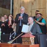 Gov. Mike Dunleavy, center, holds a copy of House Bill 123, providing state recognition for Alaskas 229 federally recognized Native tribes, at an event hosted by the Alaska Federation of Natives in Anchorage, Alaska, on Thursday, July 28, 2022. (Photo provided by the Alaska Federation of Natives)