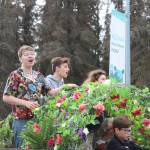 The cast of Tarzan rides the Triumvirate Theatre float during the Independence Day parade in downtown Kenai, Alaska on Monday, July 4, 2022. (Camille Botello/Peninsula Clarion)